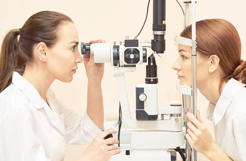 Woman undergoing eye exam by her optometrist while having eye dilated.