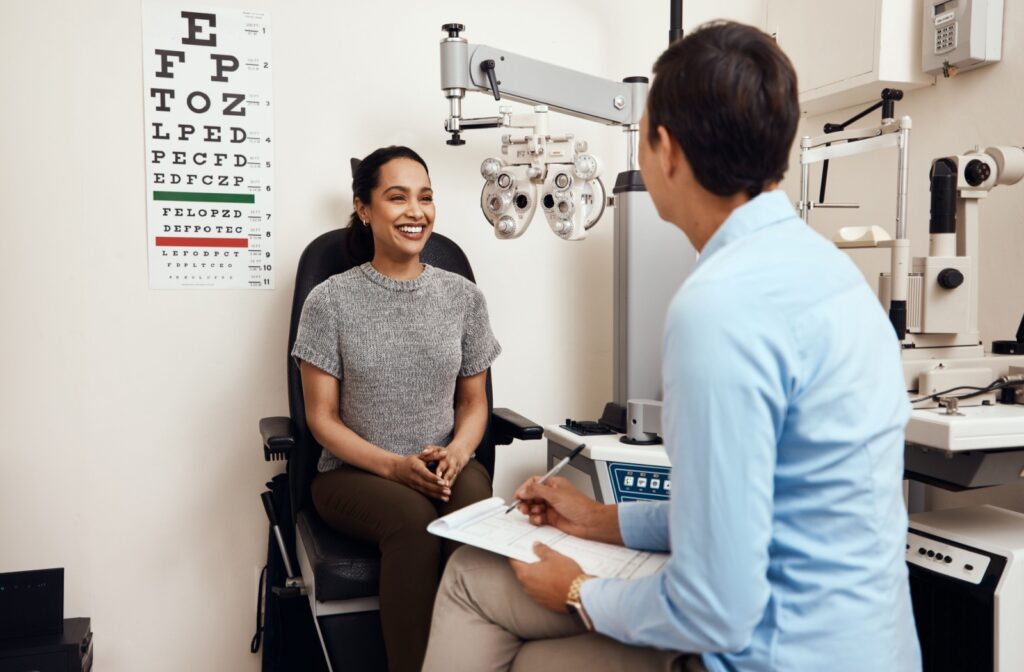 Young woman sitting at an optometrist's office discussing her eye health with her eye doctor