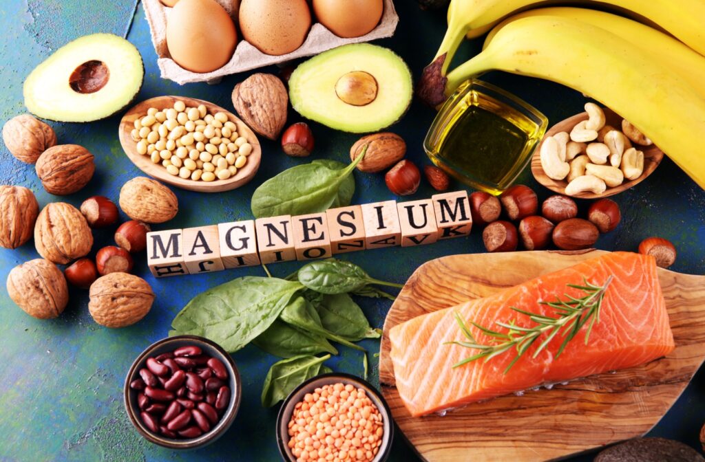A collection of magnesium-rich foods lies around blocks that spell out "magnesium."